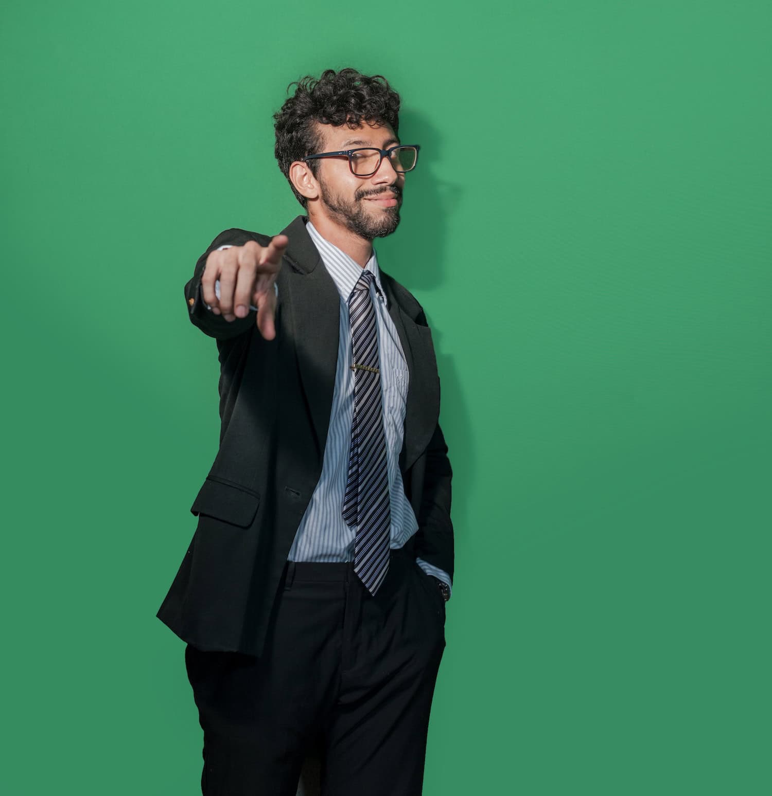 a man in a suit pointing at the camera